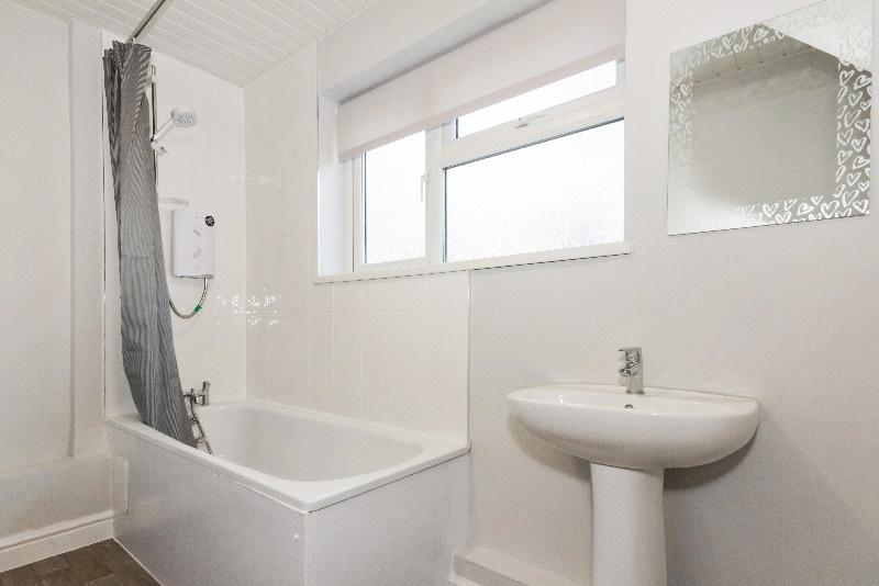 This well-maintained bathroom features a clean ...