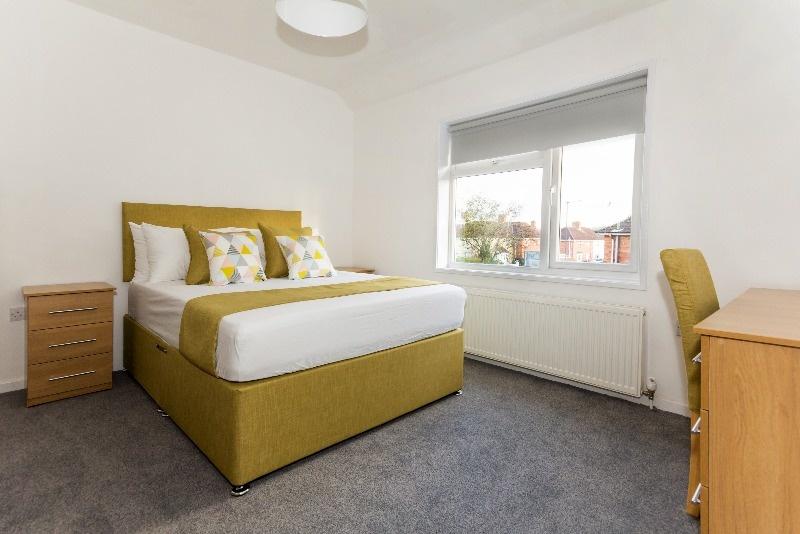 A bright and cozy double bedroom featuring a co...