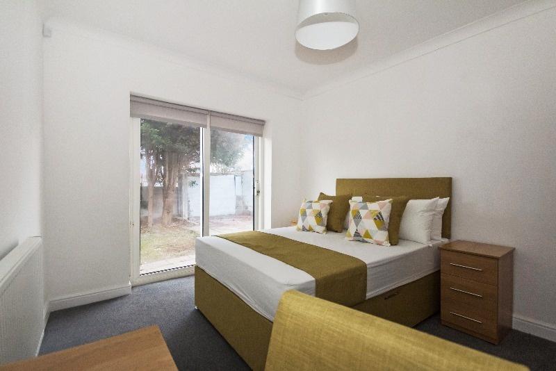 Bright and inviting double bedroom featuring la...