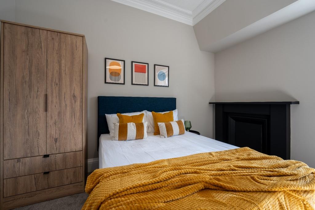 A beautifully styled double bedroom featuring a...