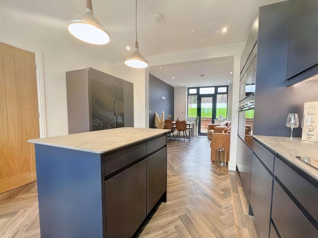Modern kitchen featuring a large central island...