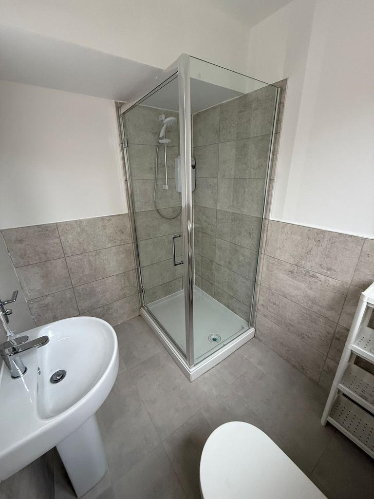 A modern bathroom featuring a spacious walk-in ...
