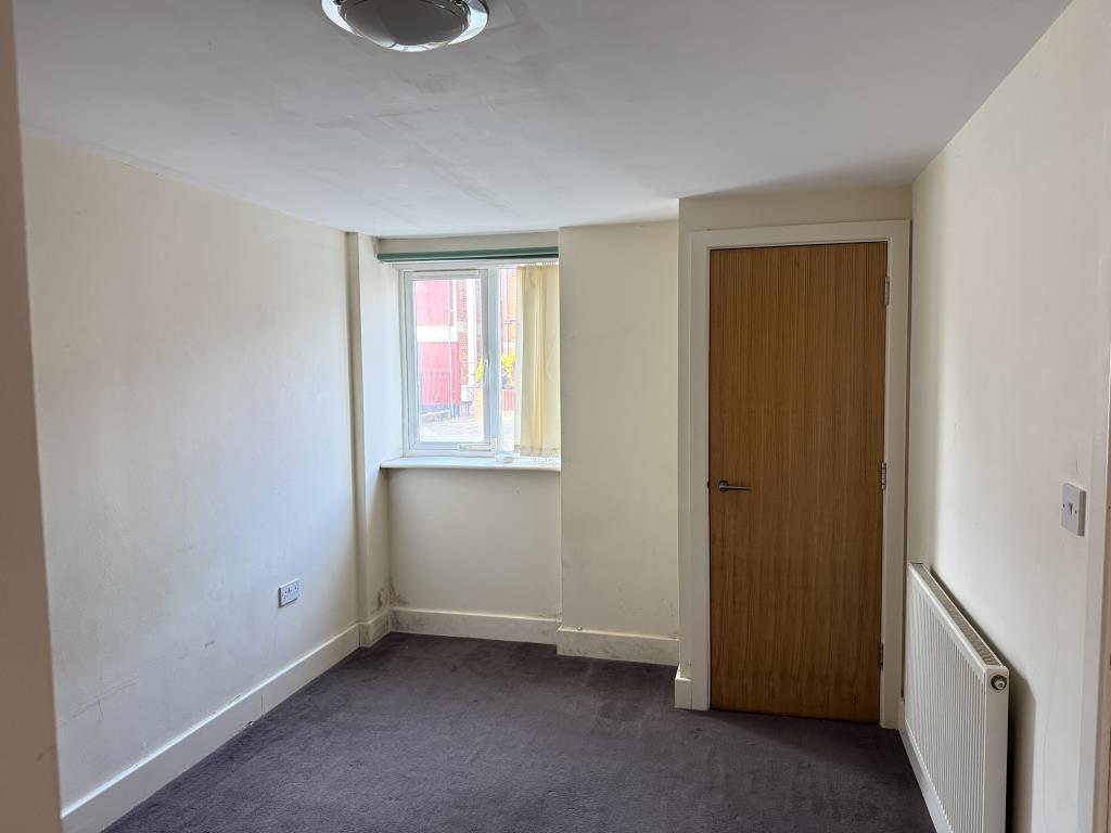 Vacant Flat B Bedroom with painted walls and carpe