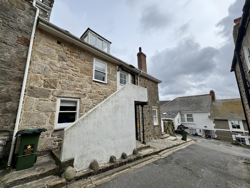 Front of the property with steps leading to the fr