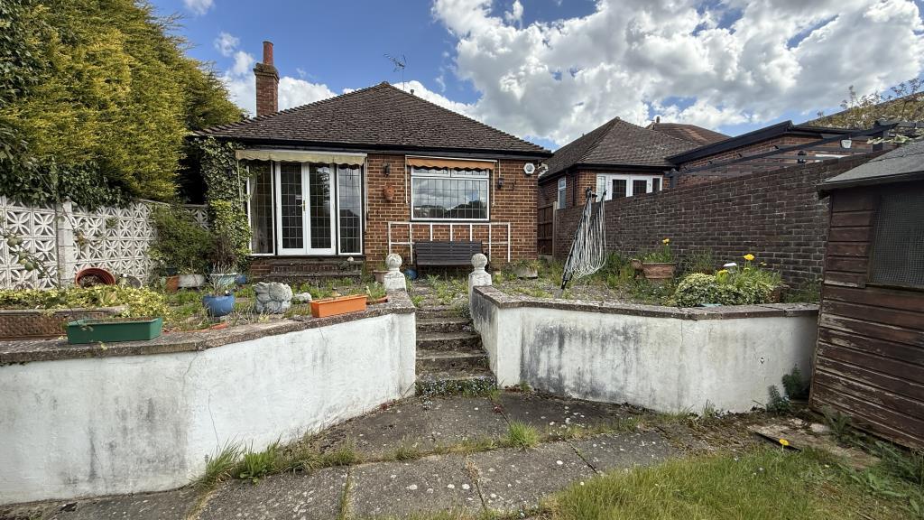 Exterior image of rear of bungalow from garden