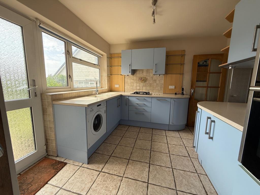 Kitchen with access to hallway and rear garden