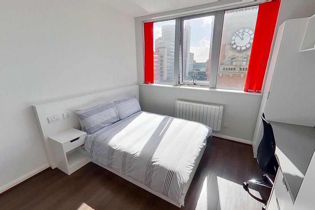 This inviting double bedroom features large win...