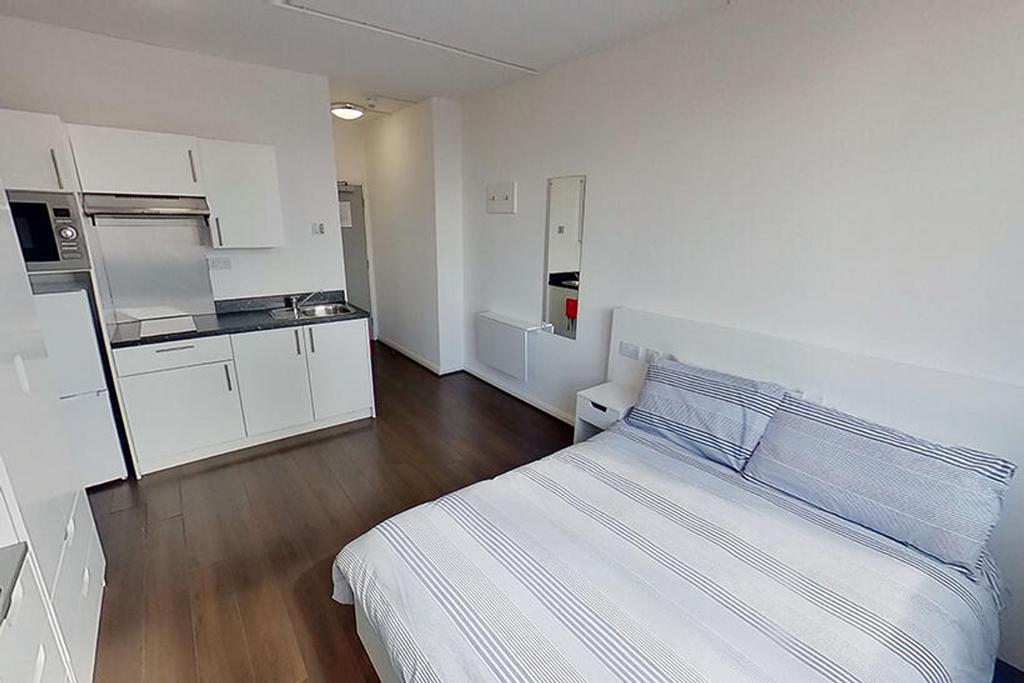 Spacious double bedroom featuring a cozy bed, m...