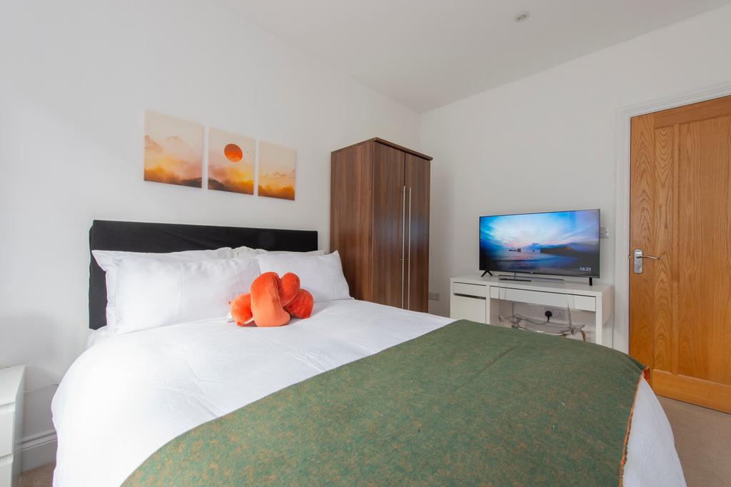 A bright and inviting double bedroom featuring ...