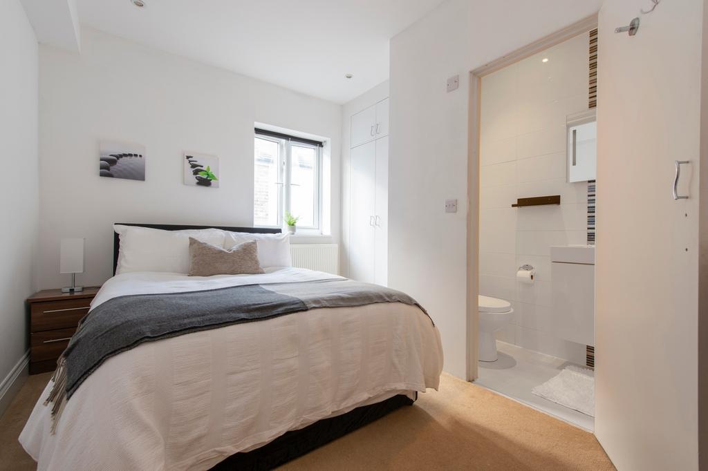 A bright and inviting double bedroom featuring ...