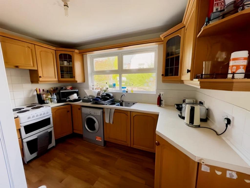 A bright and functional kitchen with ample stor...
