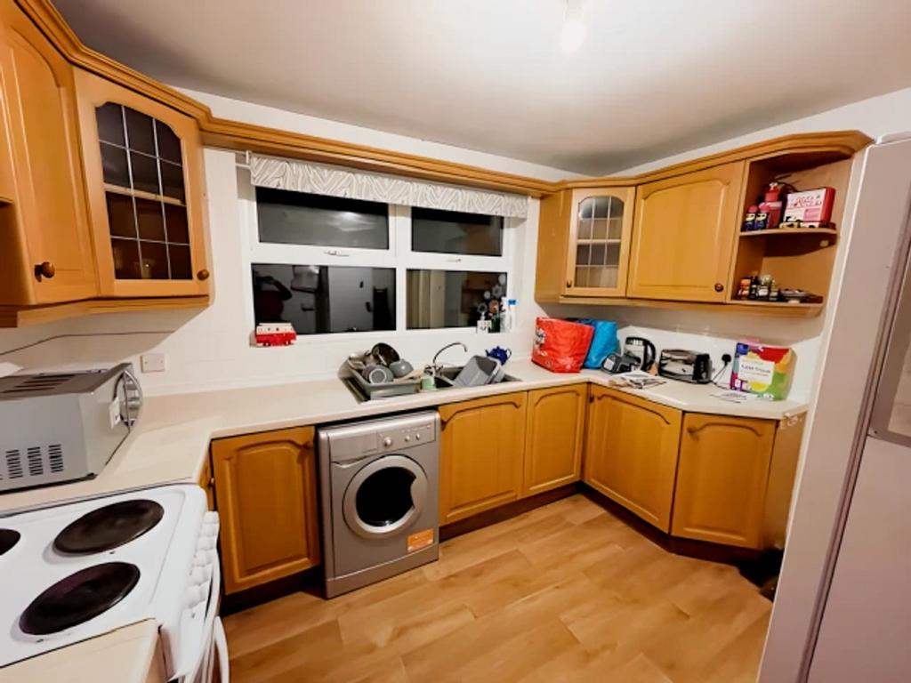 A cozy kitchen with ample storage and natural l...