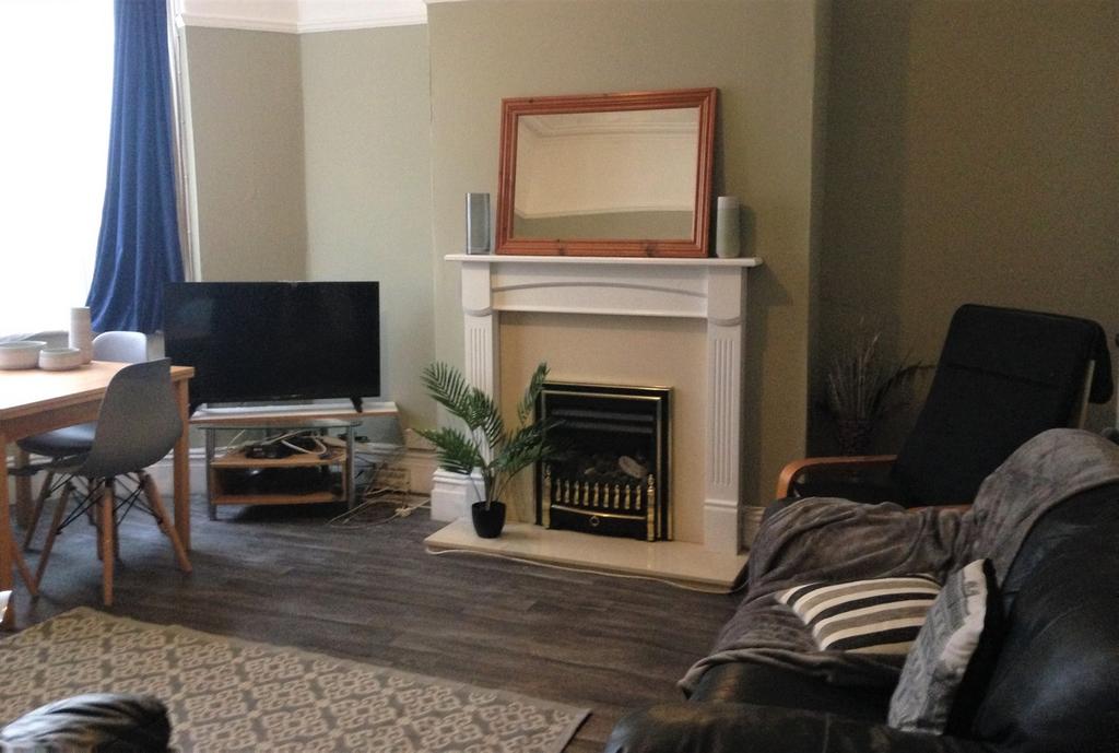 A cozy living room featuring a stylish fireplac...