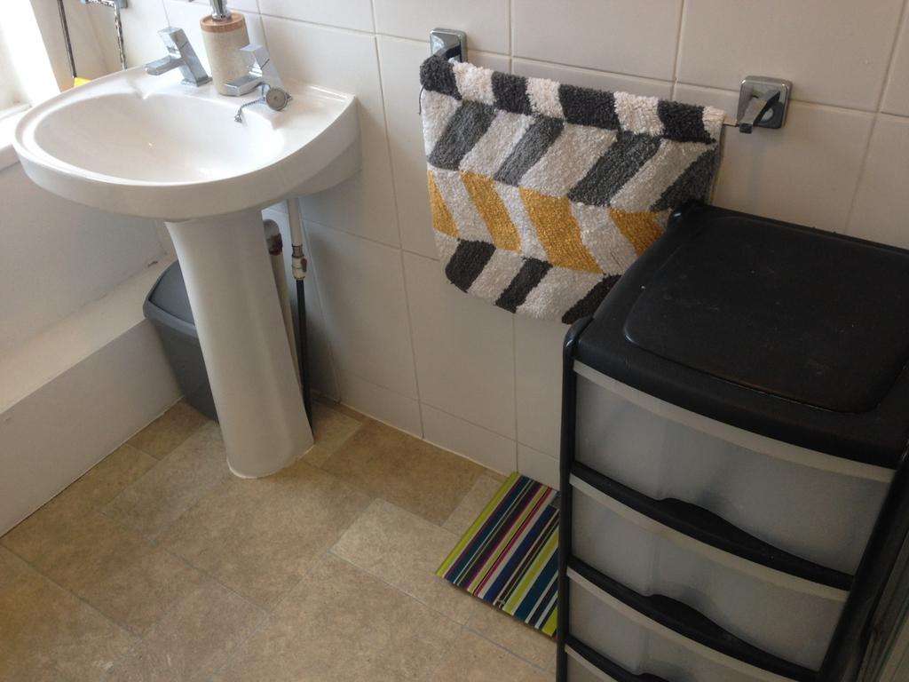 Bright and tidy bathroom featuring a stylish si...