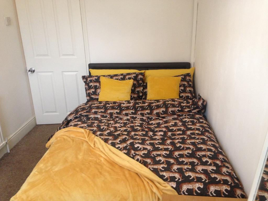 A cozy double bedroom featuring a stylish patte...