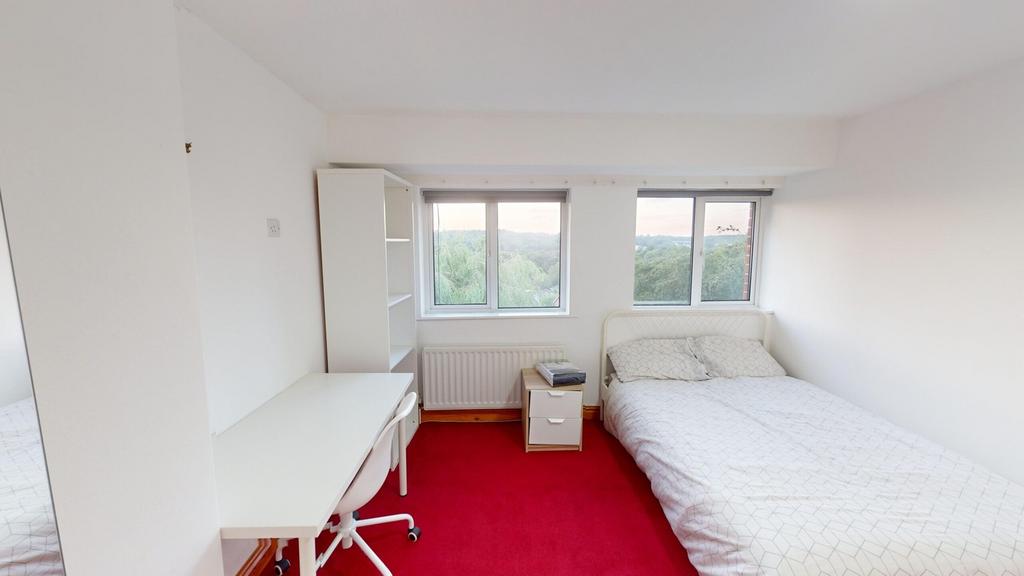 A bright and inviting double bedroom with large...