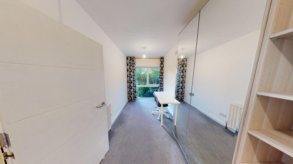 A bright and spacious double bedroom featuring ...