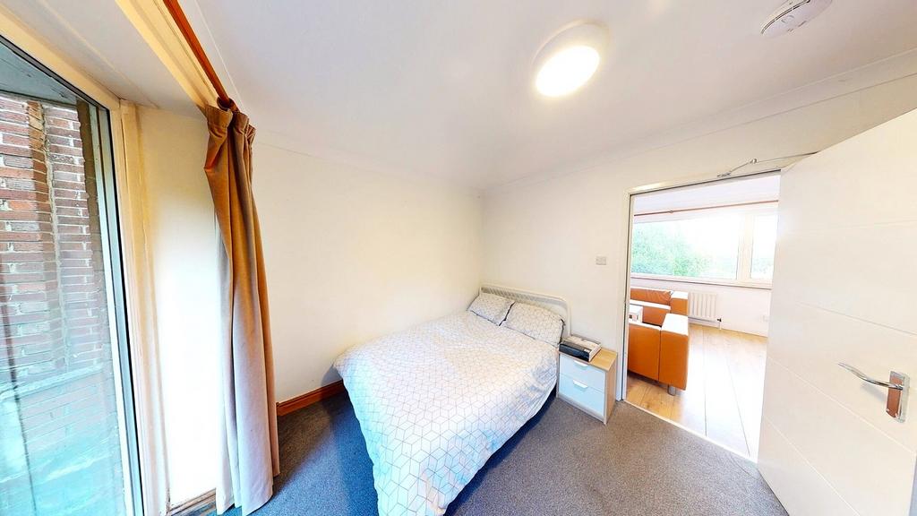 A bright and inviting double bedroom with ample...