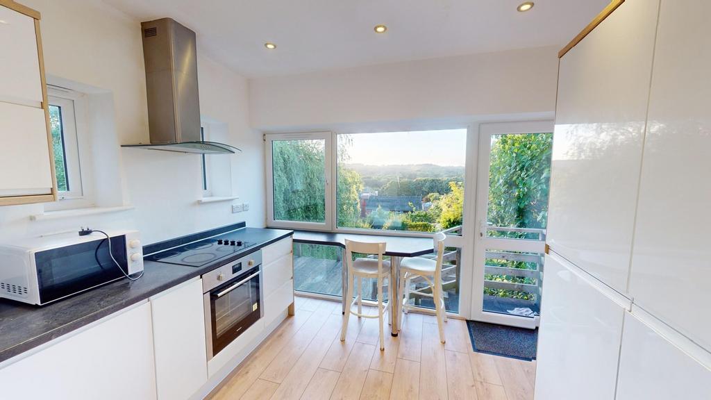 A bright and modern kitchenette with stunning v...