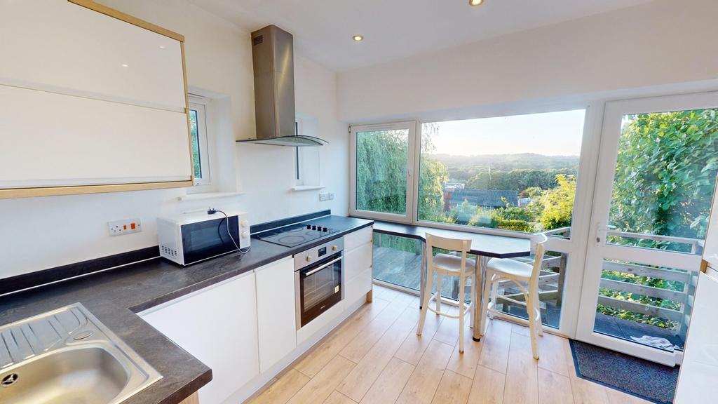 A bright and modern kitchenette with stunning v...