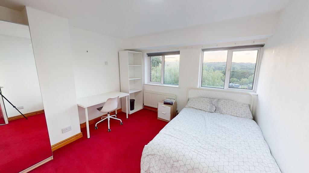 A bright and inviting double bedroom with moder...