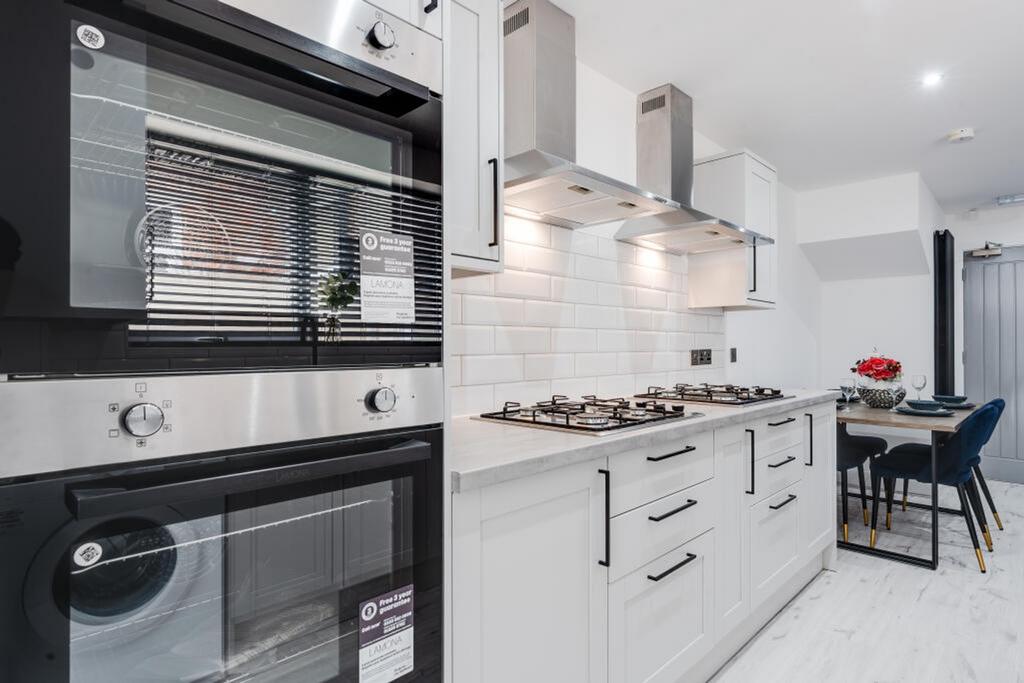Modern kitchen featuring sleek cabinetry and hi...
