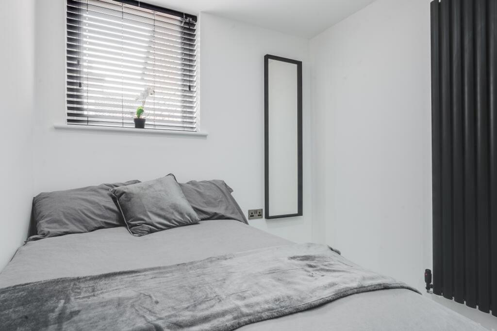 This inviting double bedroom features a comfort...