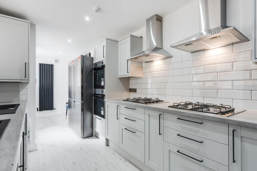 Modern kitchen featuring sleek cabinetry, high-...