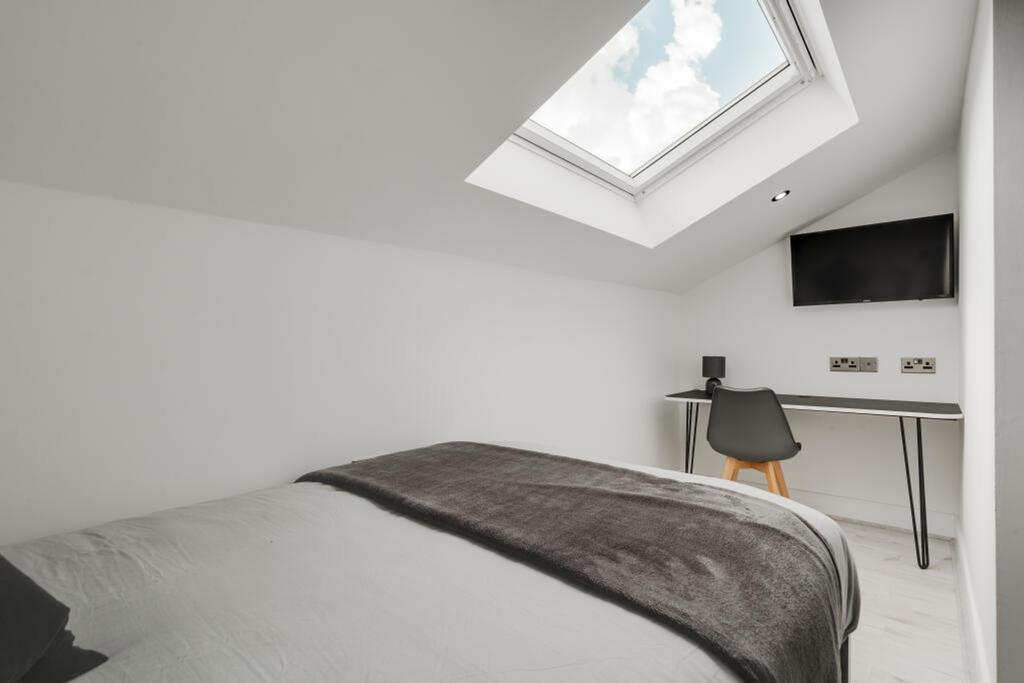 Bright and spacious double bedroom featuring a ...