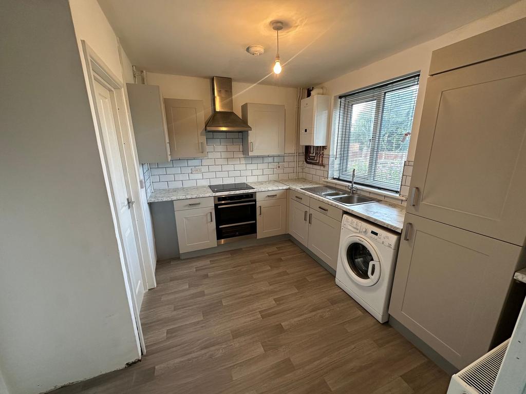 Bright and modern kitchen featuring ample cabin...