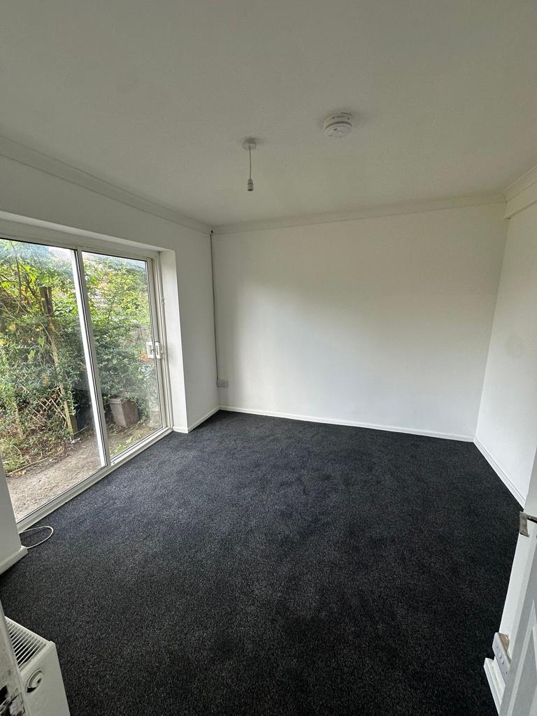 Bright and spacious bedroom featuring large sli...