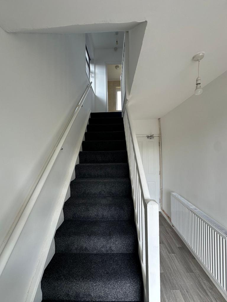A clean and well-maintained staircase with dark...