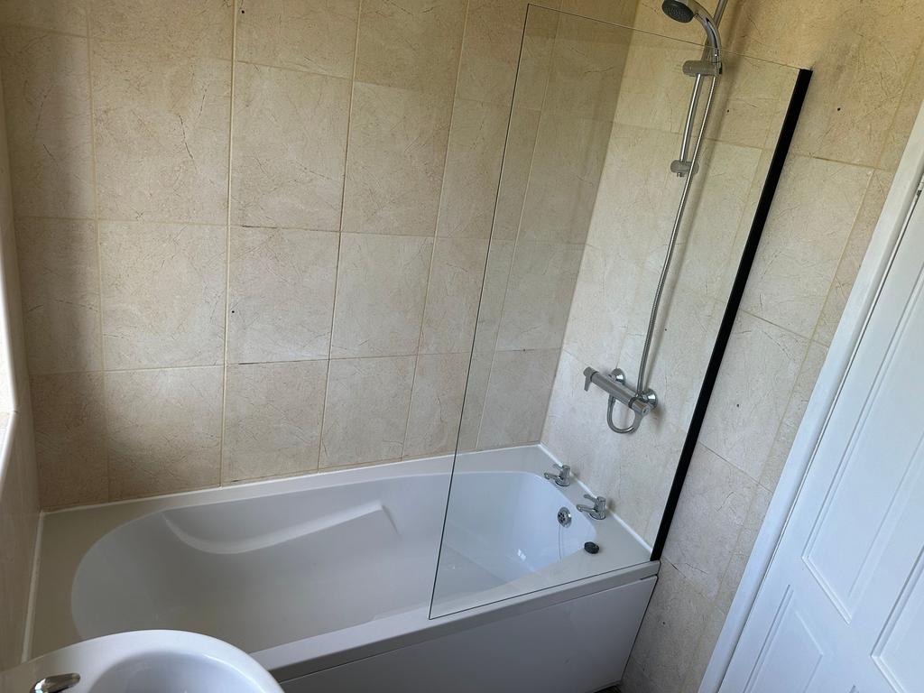 A modern bathroom suite featuring a clean white...
