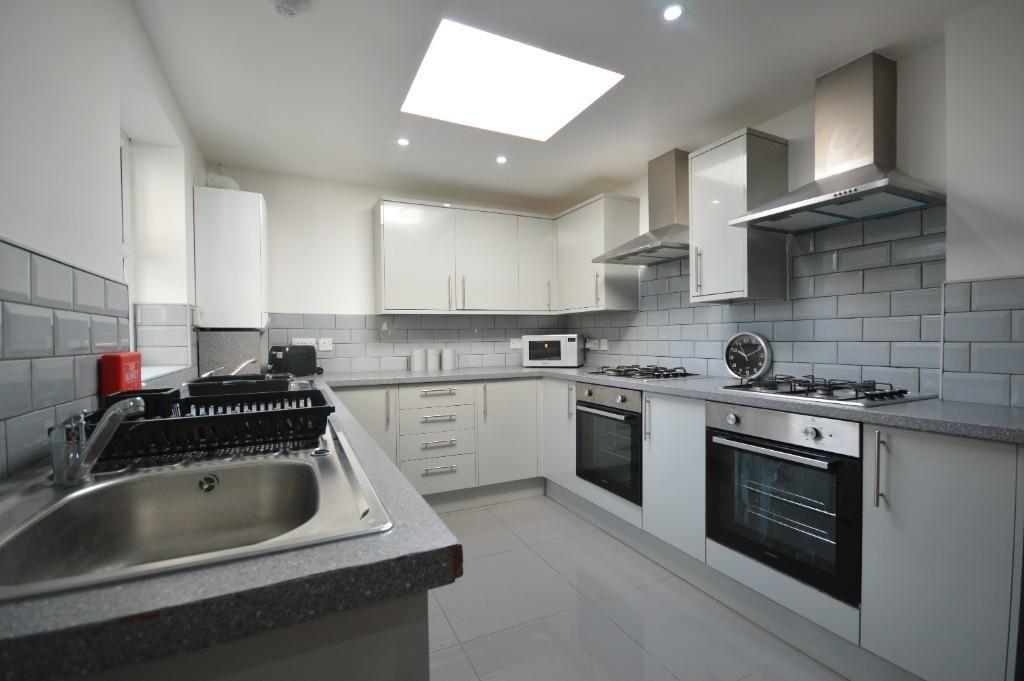 This modern kitchen features sleek cabinetry an...