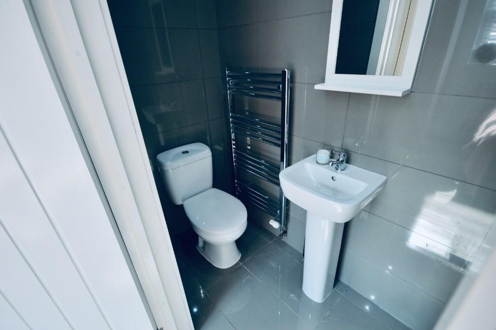 A modern bathroom featuring sleek fixtures, a s...