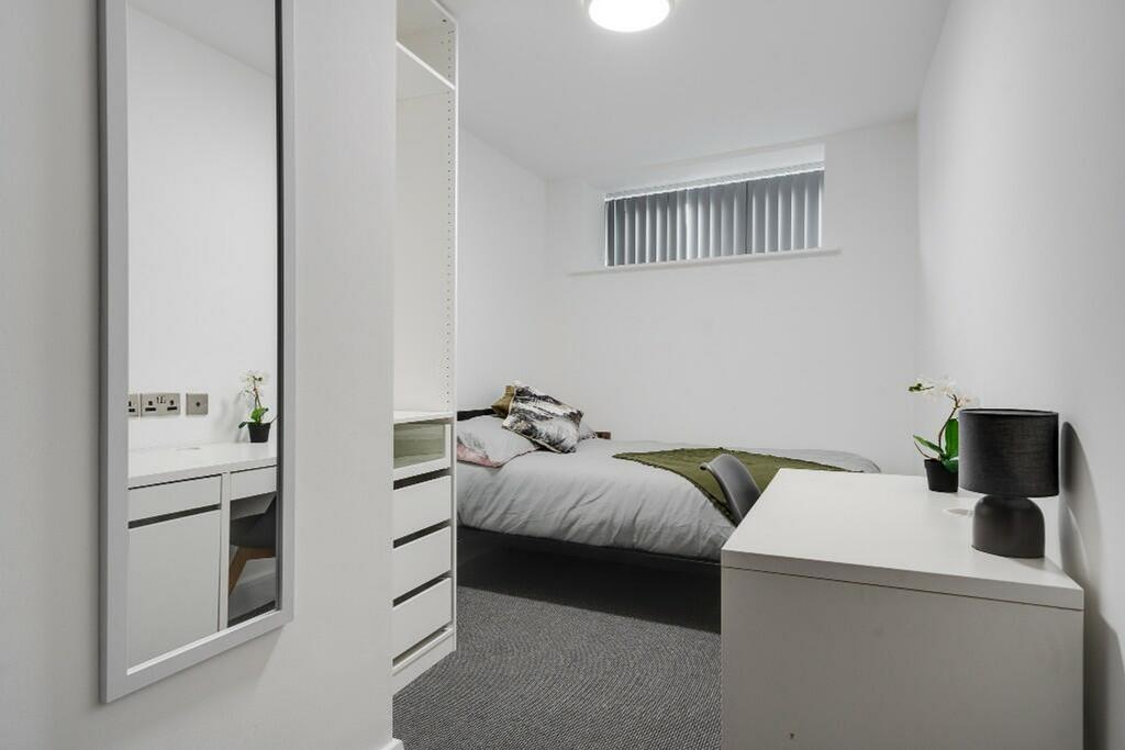 A stylish double bedroom featuring a cozy bed, ...