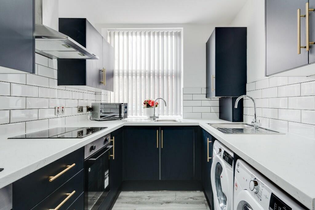 Modern kitchen with sleek cabinetry and ample n...