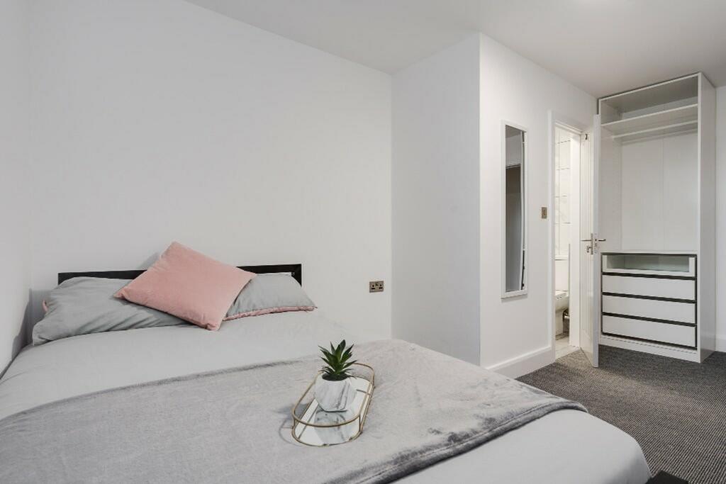 This inviting double bedroom features a cozy la...
