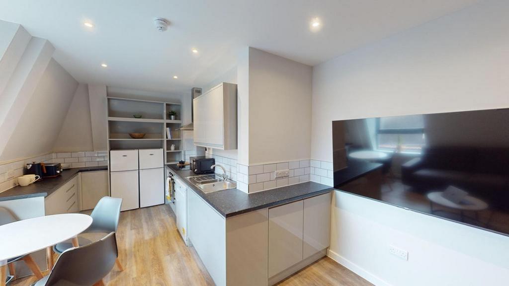 A modern and spacious kitchenette with ample na...