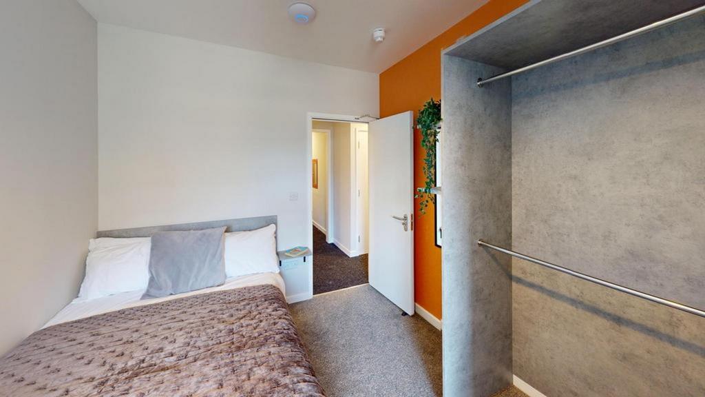 A cozy and inviting double bedroom with warm co...