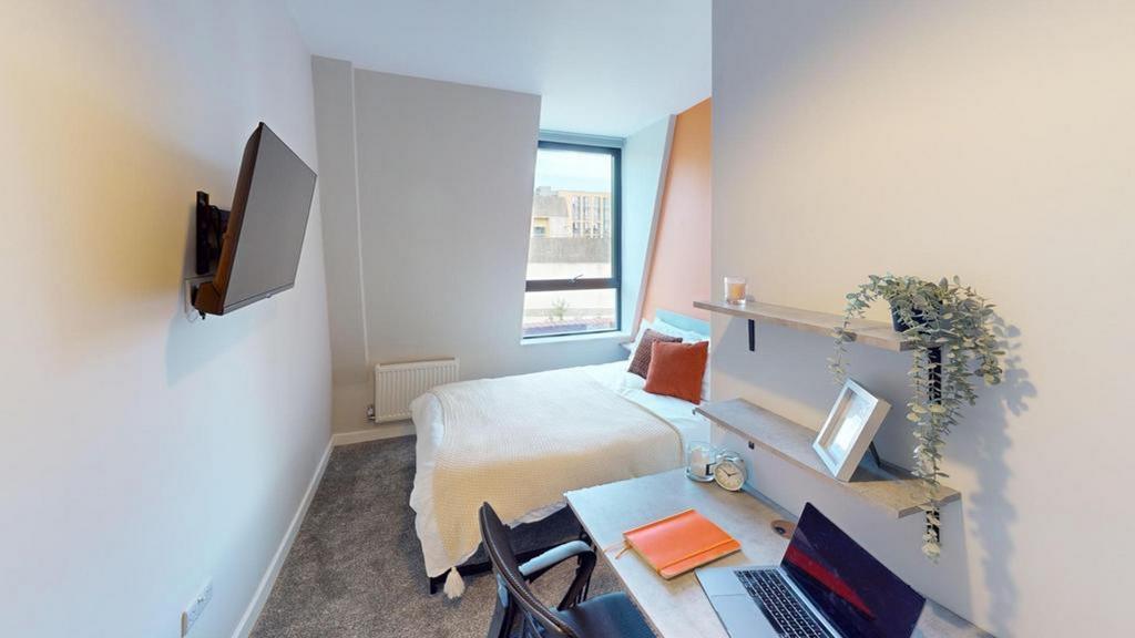 A bright and inviting double bedroom with moder...