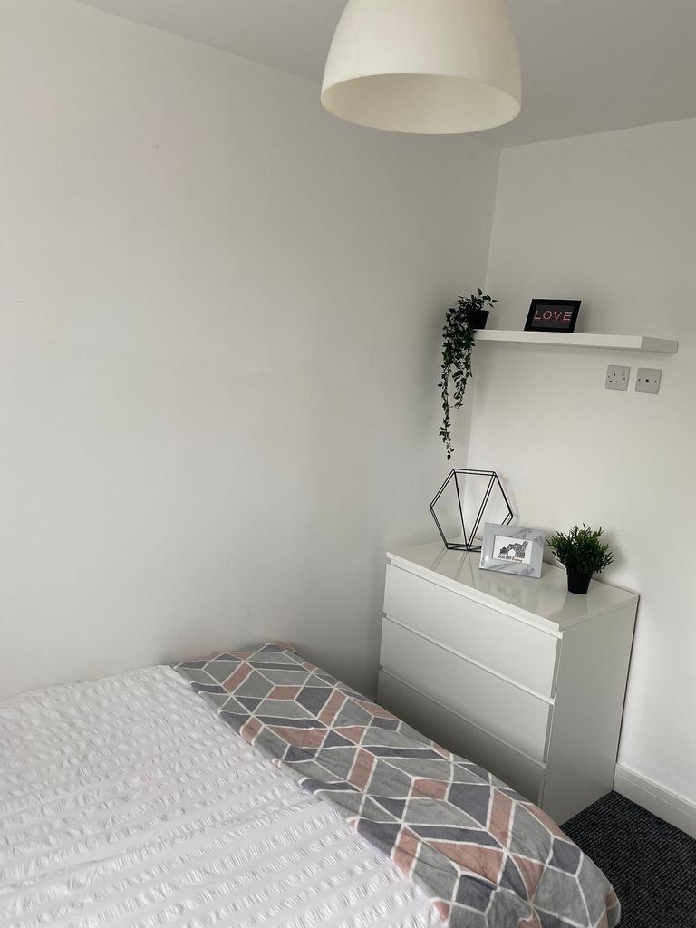 This charming double bedroom features a cozy at...
