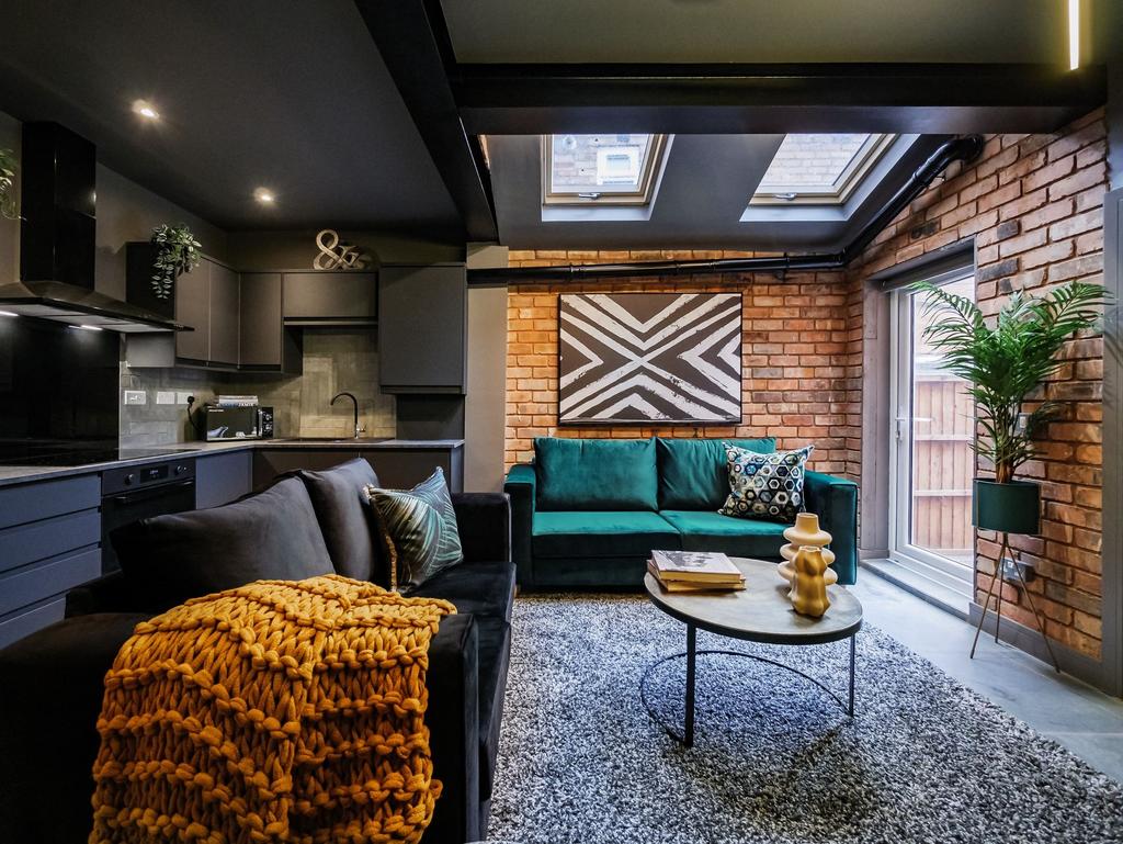 Contemporary living room with stylish exposed b...