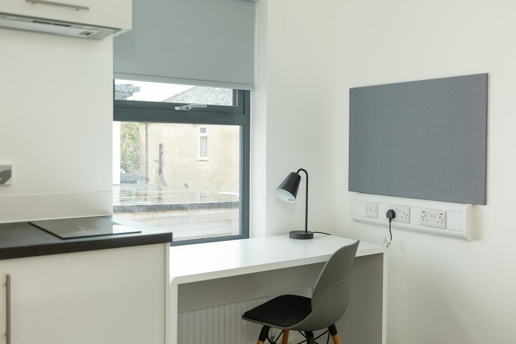 A modern kitchenette with ample natural light a...