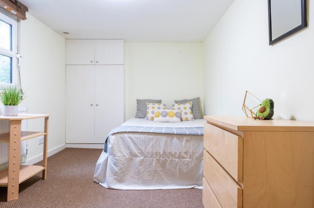 This inviting double bedroom features a cozy at...
