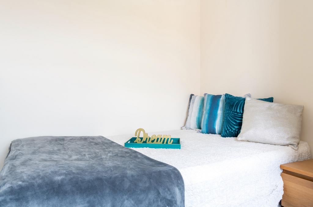 A cozy double bedroom featuring a comfortable b...