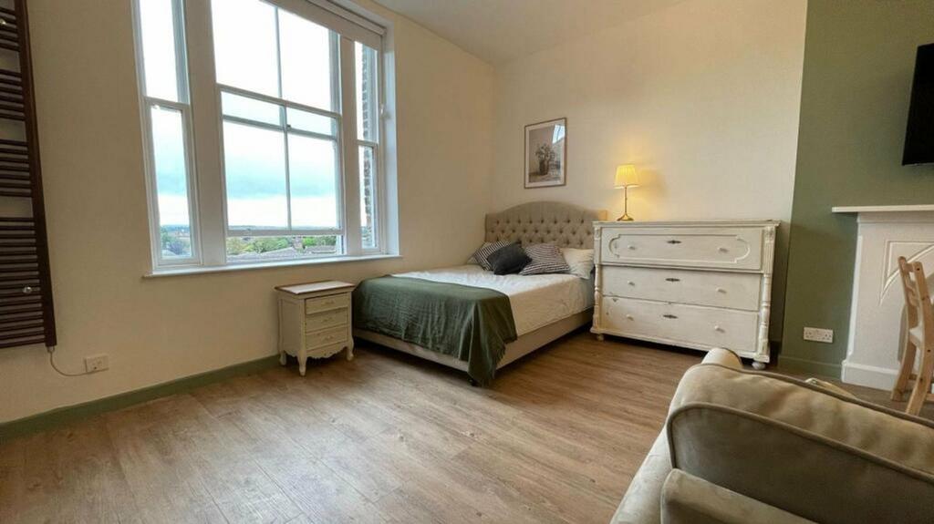 A bright and inviting double bedroom featuring ...