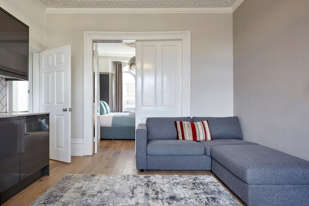A clean and inviting living room featuring a gr...