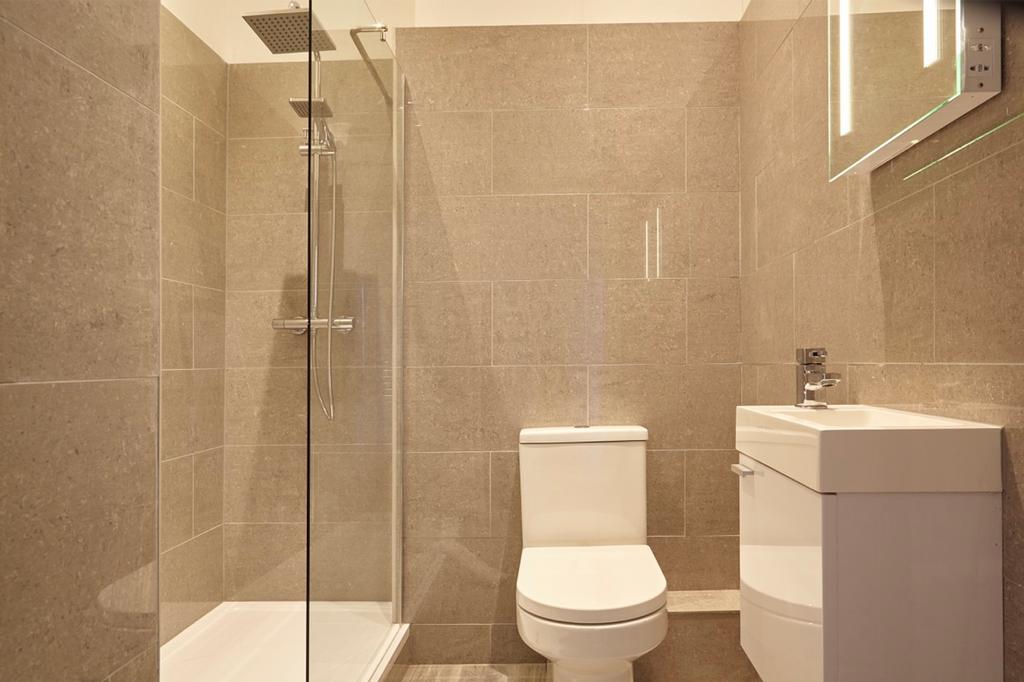 A modern and clean bathroom featuring a shower ...