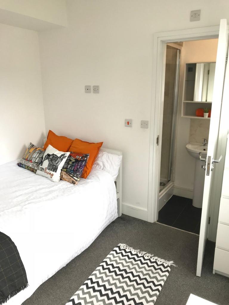 Cozy double bedroom featuring a comfortable bed...